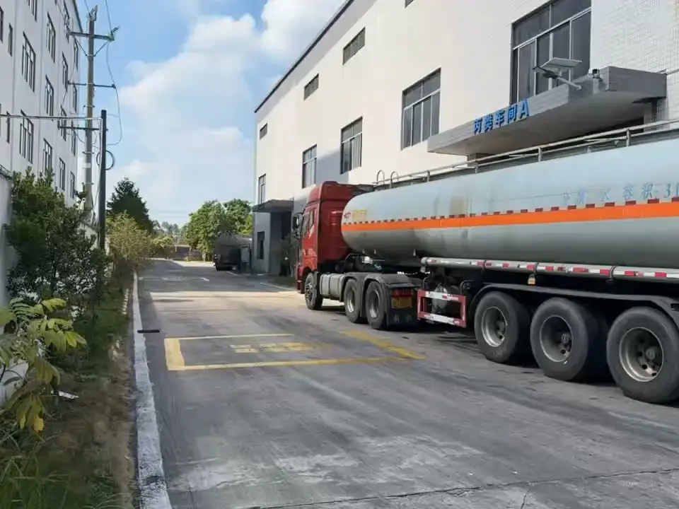 Bulk tanker truck delivering concrete admixture to a ready-mix concrete plant